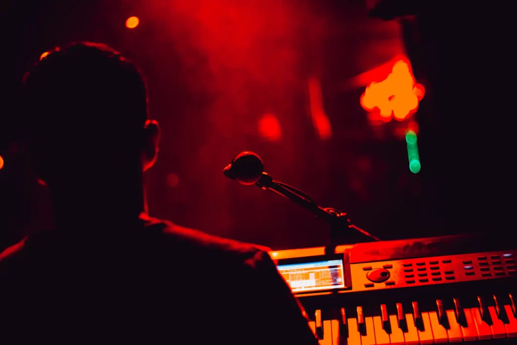 artist with a microphone and an electronic keyboard