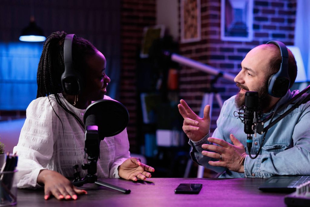 two people talking in a podcast studio
